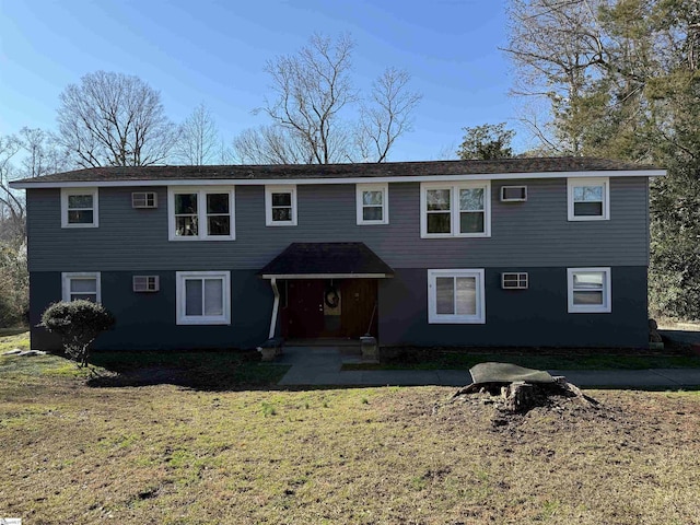 view of property featuring a front lawn