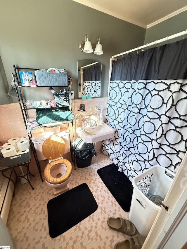 bathroom featuring tile walls, sink, crown molding, and toilet