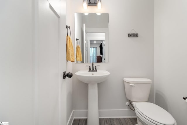 bathroom with sink, wood-type flooring, and toilet