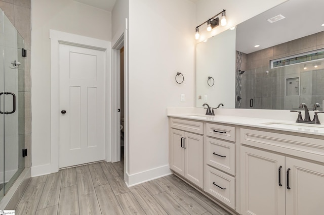 bathroom featuring vanity, toilet, hardwood / wood-style floors, and walk in shower