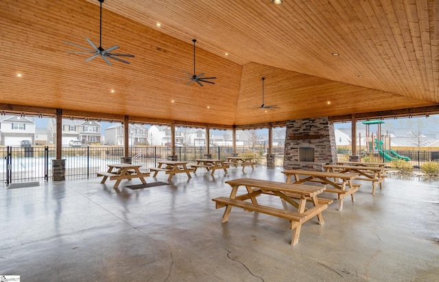 sunroom / solarium with a water view, lofted ceiling, wood ceiling, and plenty of natural light