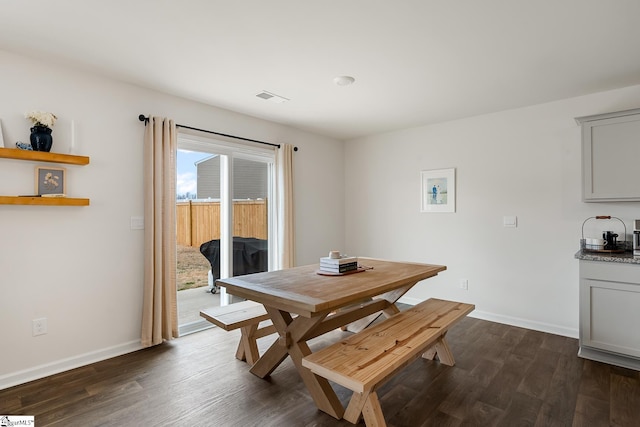 dining space with dark hardwood / wood-style flooring