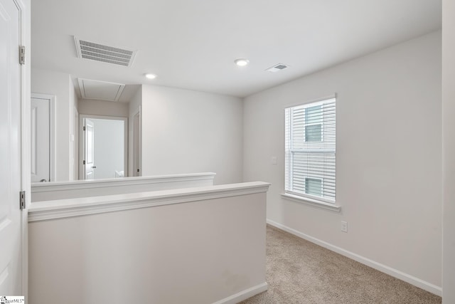 hallway with light carpet