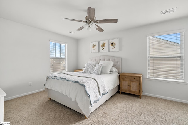 bedroom with light colored carpet and ceiling fan