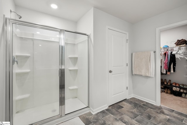 bathroom featuring a shower with shower door