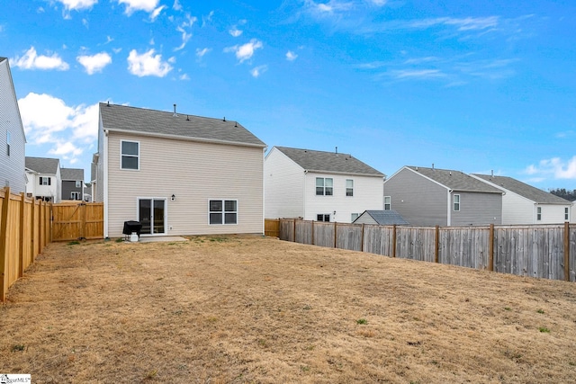 rear view of property with a yard