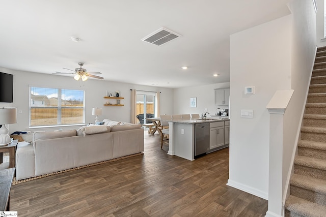 living room featuring dark hardwood / wood-style floors, sink, and ceiling fan