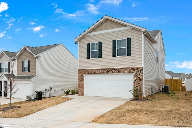 front of property featuring a garage, central AC unit, and a front lawn