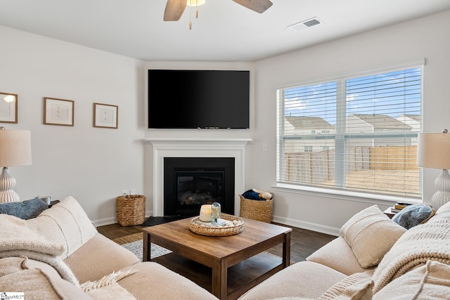 living room with dark wood-type flooring and ceiling fan