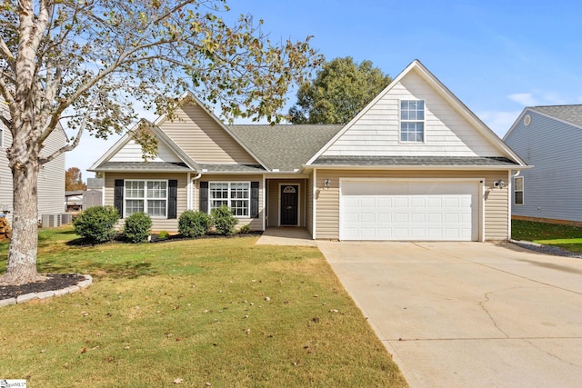 view of front of house with a garage and a front lawn