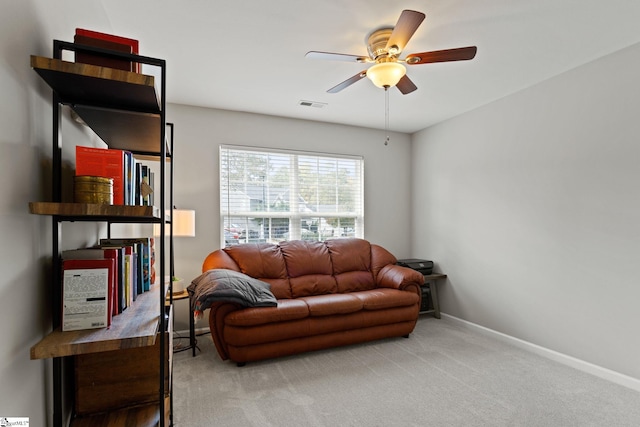 living room featuring carpet floors and ceiling fan