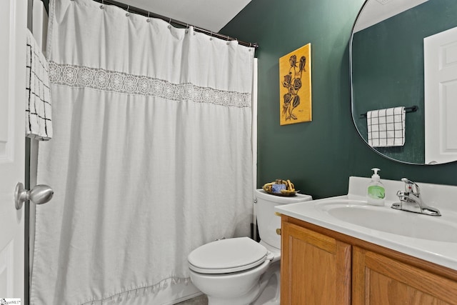 bathroom featuring vanity, walk in shower, and toilet