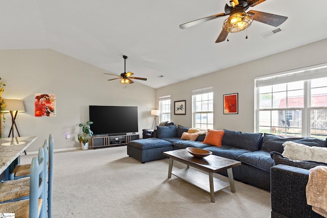 carpeted living room with vaulted ceiling and ceiling fan