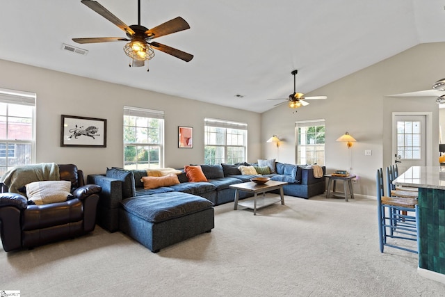 living room with lofted ceiling, light colored carpet, and ceiling fan