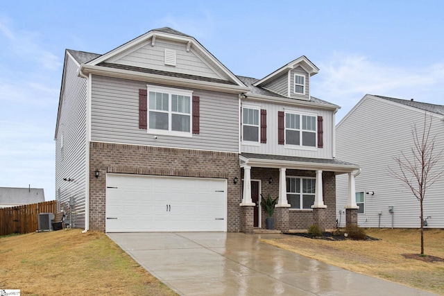 craftsman house with a garage, cooling unit, covered porch, and a front lawn