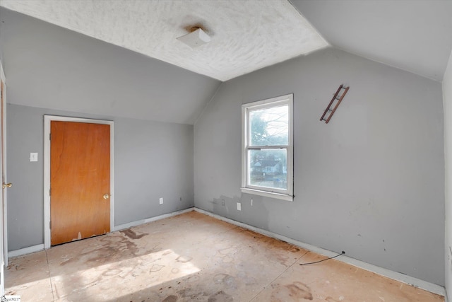 additional living space featuring vaulted ceiling