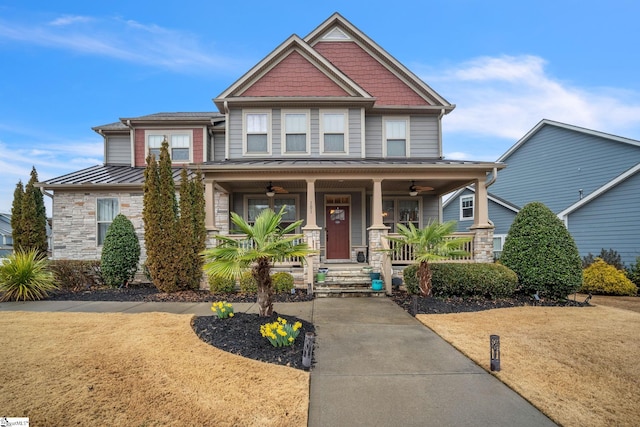 craftsman-style home with a front lawn, ceiling fan, and covered porch