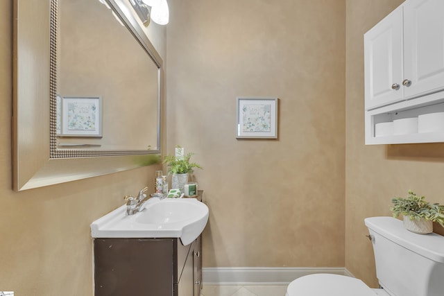 bathroom featuring vanity, tile patterned floors, and toilet