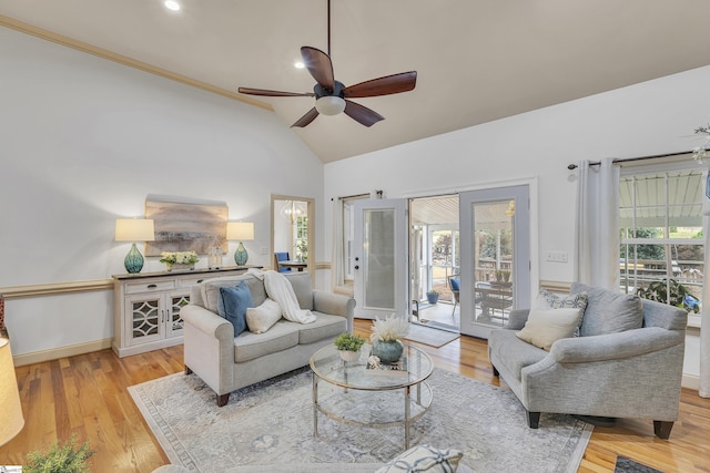 living room featuring ceiling fan, plenty of natural light, high vaulted ceiling, and light hardwood / wood-style floors