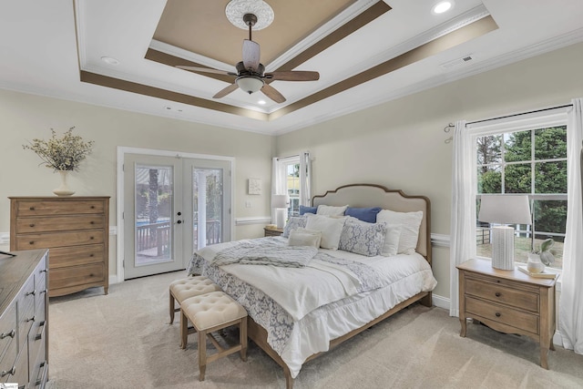 carpeted bedroom with a raised ceiling, crown molding, access to outside, and french doors