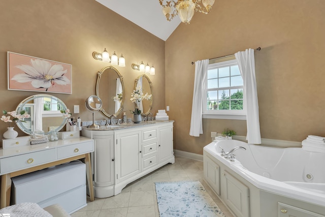 bathroom featuring lofted ceiling, a bathtub, vanity, and a wealth of natural light