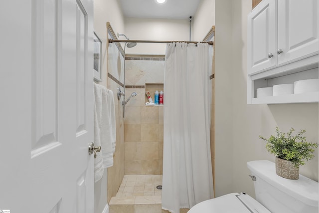 bathroom with toilet and a shower with shower curtain