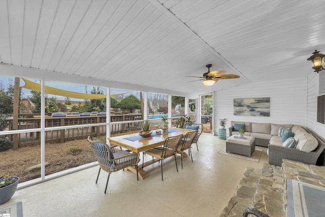 sunroom / solarium featuring ceiling fan