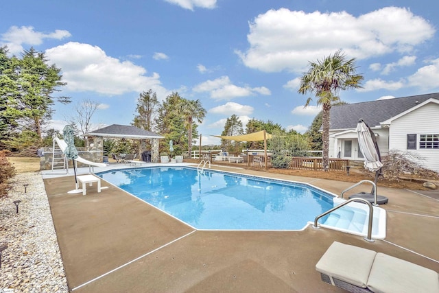 view of swimming pool with a gazebo, a patio, and a water slide