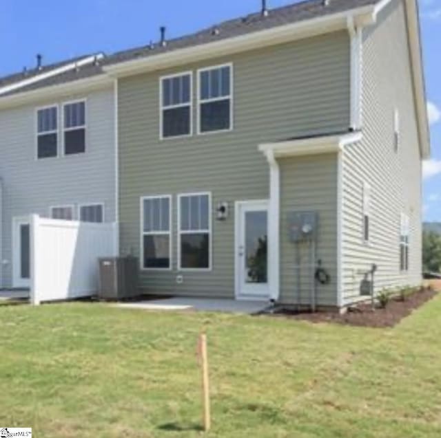 back of property featuring a yard, central AC unit, and a patio