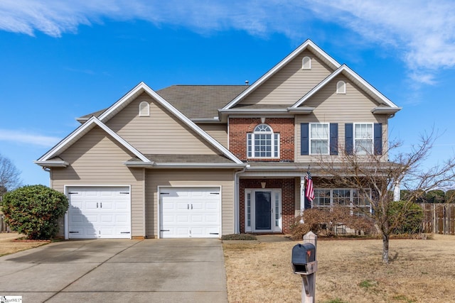 view of front of home with a garage and a front lawn