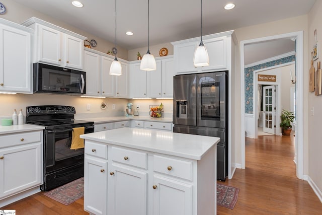 kitchen with refrigerator with ice dispenser, white cabinetry, black range with electric stovetop, hanging light fixtures, and a center island