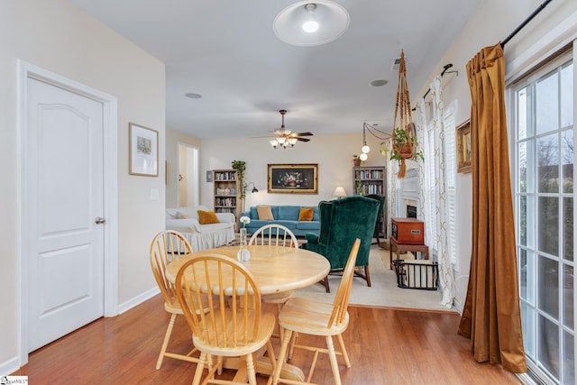 dining room with hardwood / wood-style flooring and ceiling fan