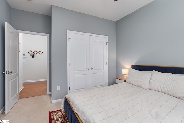 bedroom featuring light carpet and a closet