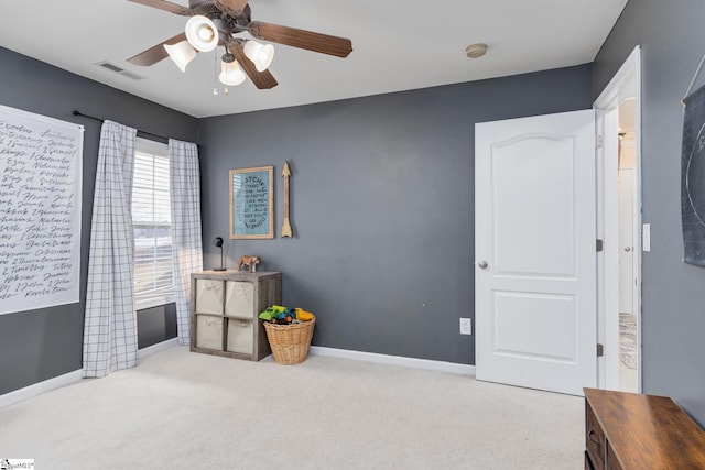 misc room with light carpet and ceiling fan