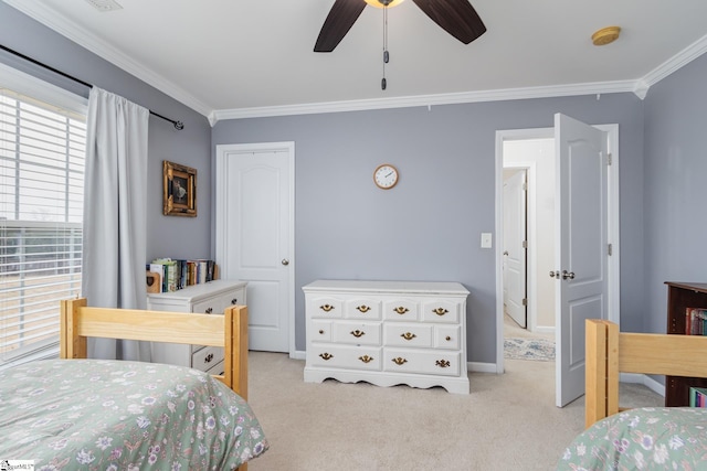 carpeted bedroom featuring crown molding and ceiling fan