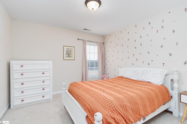 bedroom featuring light carpet