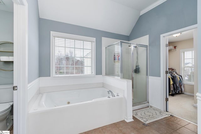 bathroom featuring tile patterned floors, toilet, separate shower and tub, and vaulted ceiling