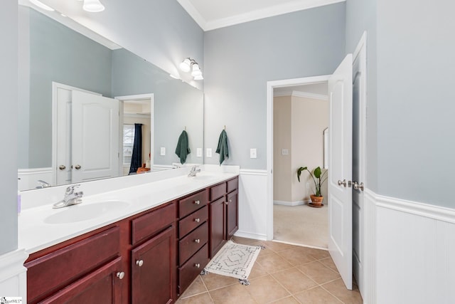 bathroom with tile patterned flooring, ornamental molding, and vanity