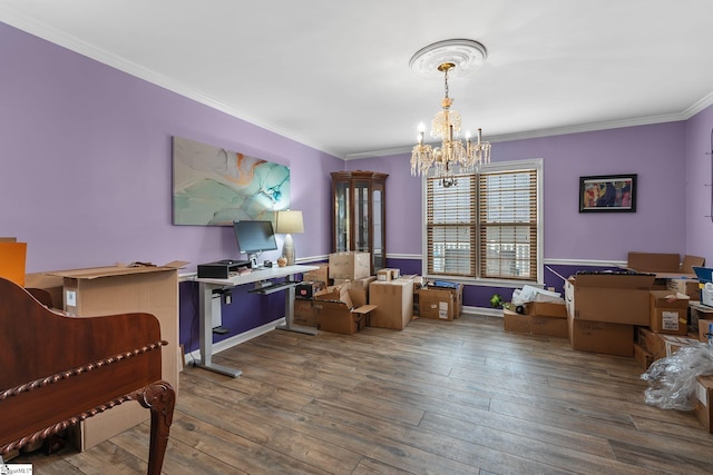 dining area with crown molding, hardwood / wood-style floors, and a notable chandelier