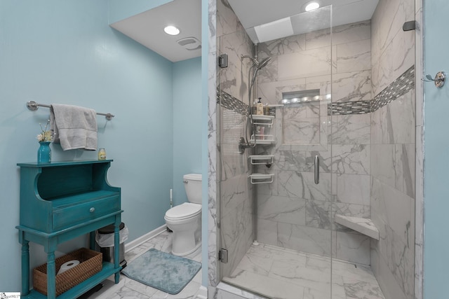 bathroom featuring toilet and a shower with shower door