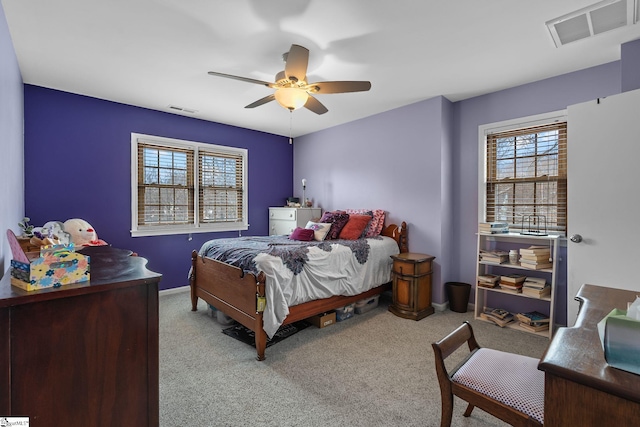 carpeted bedroom with multiple windows and ceiling fan