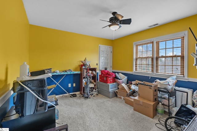 interior space with ceiling fan and carpet flooring