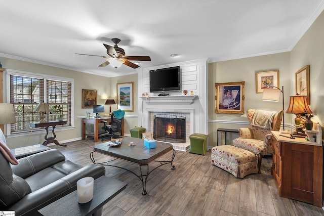 living room featuring hardwood / wood-style flooring, a fireplace, crown molding, and ceiling fan