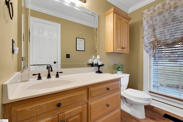 bathroom with vanity, ornamental molding, hardwood / wood-style floors, and toilet