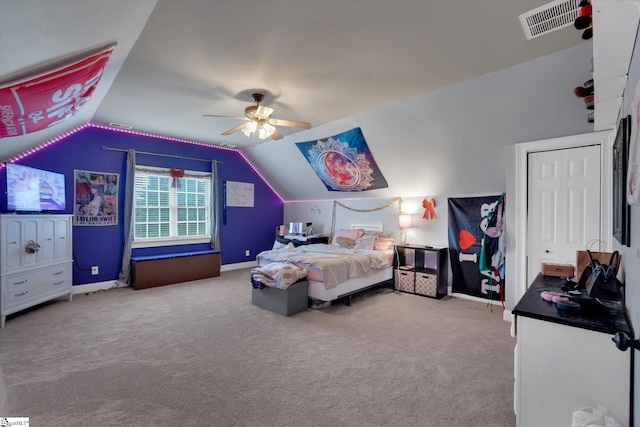 bedroom with vaulted ceiling, light colored carpet, and ceiling fan