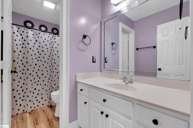 bathroom with hardwood / wood-style flooring, vanity, toilet, and a shower with shower curtain