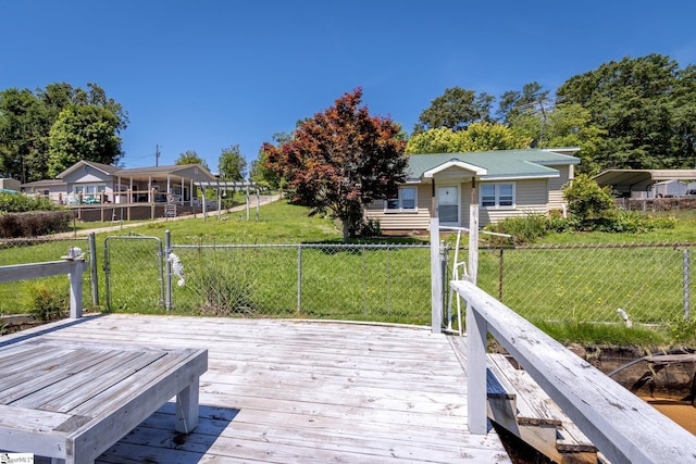 exterior space featuring a wooden deck and a lawn