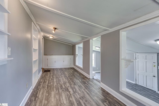 spare room with dark hardwood / wood-style floors and vaulted ceiling