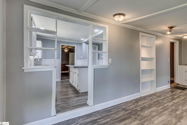 interior space with wood-type flooring, ornamental molding, and ceiling fan