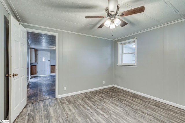 spare room with hardwood / wood-style flooring, ceiling fan, and ornamental molding